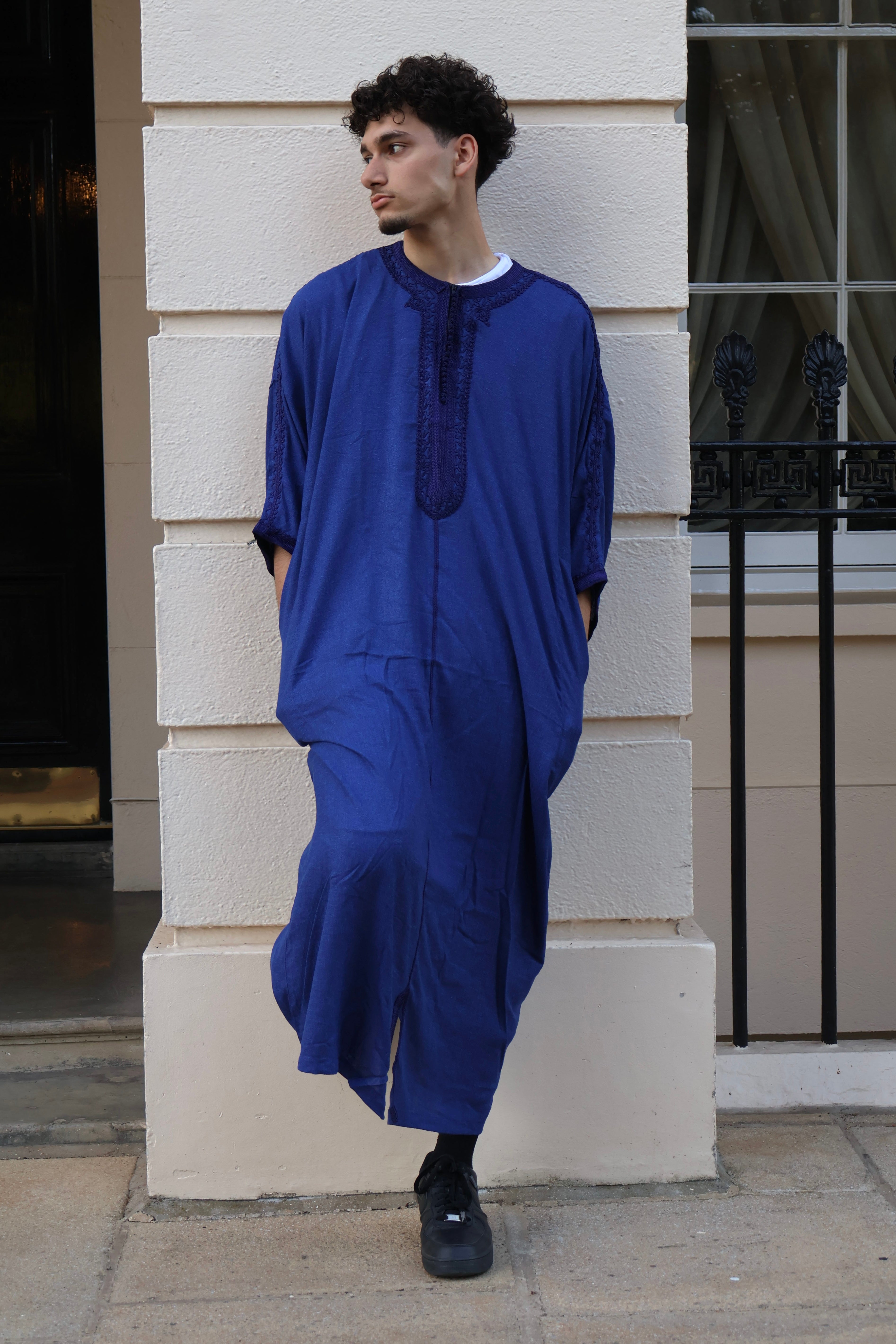 Man looking to the side, wearing a flowing royal blue men&