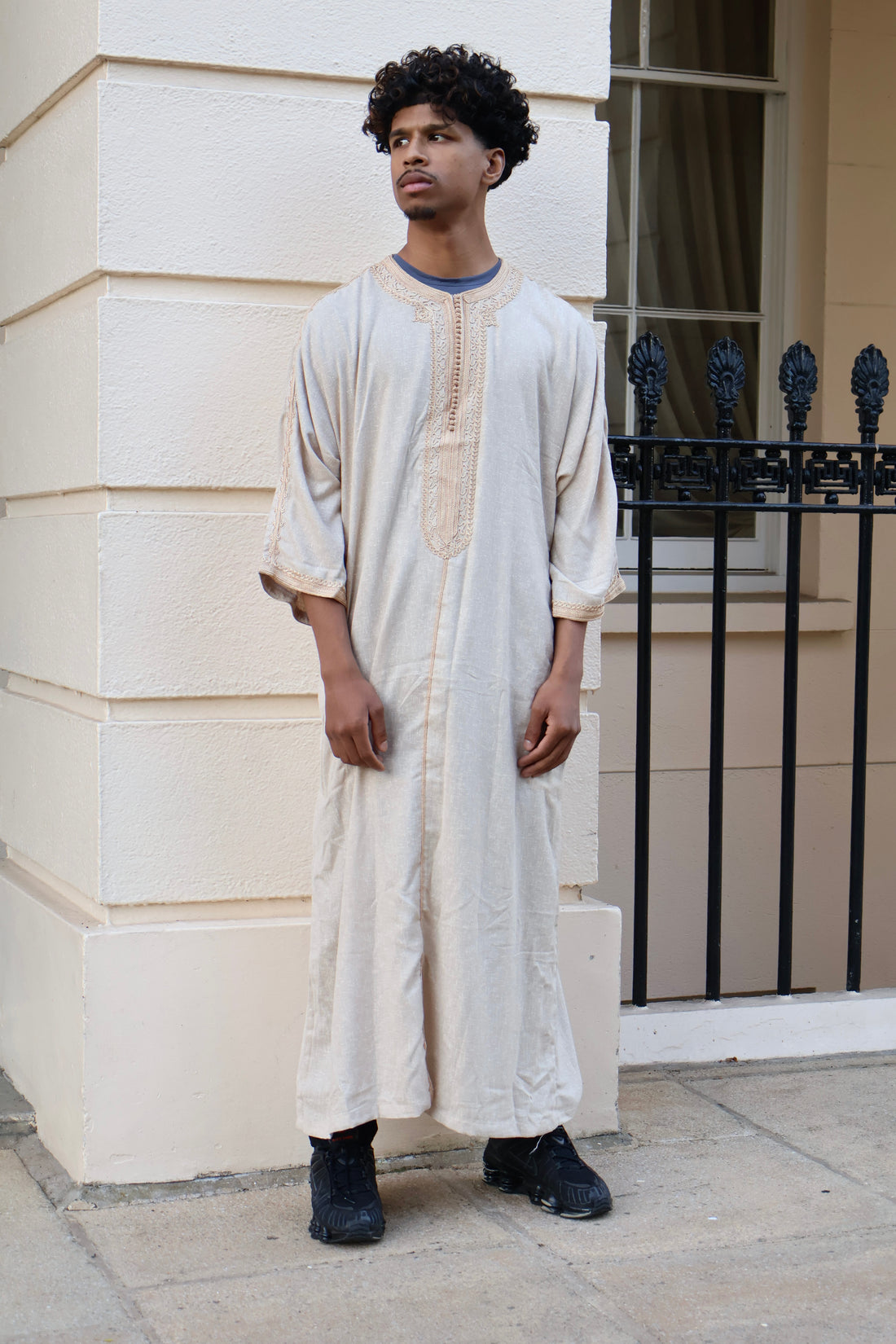 Man standing, facing forward, wearing a luxurious cream men&